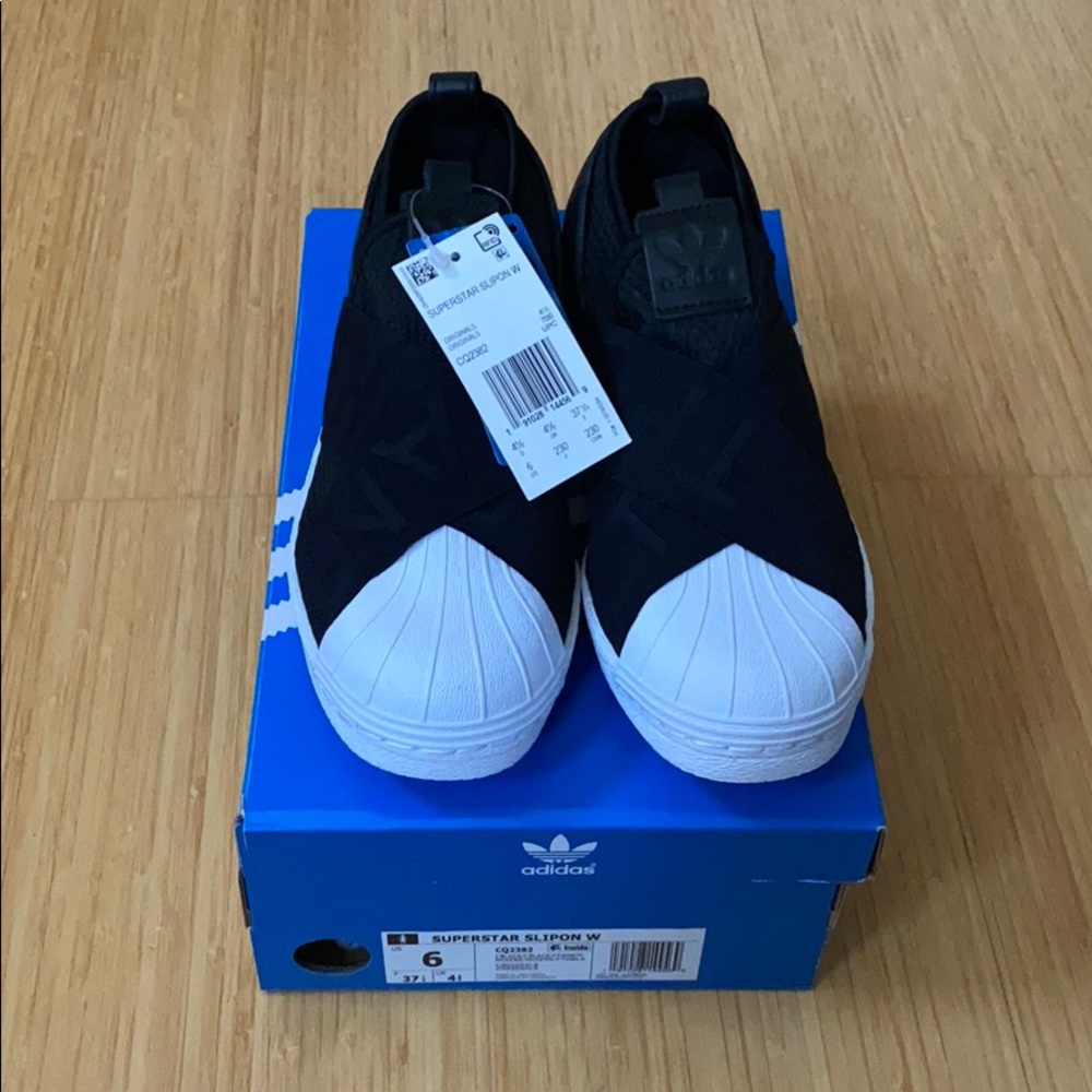 Pair of black Adidas superstar slip-on